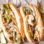 Chicken Philly Pizza — slices of tender chicken, sautéed peppers and onions, and melty cheese on a golden crust at WiseGuys Pizza.