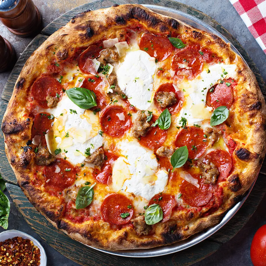 The Italian Deli Pizza from WiseGuys—loaded with deli meats, savory flavors, and melty cheese on a perfect crust.