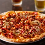 The Meat Lovers Pizza at WiseGuys — a hearty feast of pepperoni, sausage, bacon, and more, layered over perfectly melted cheese.