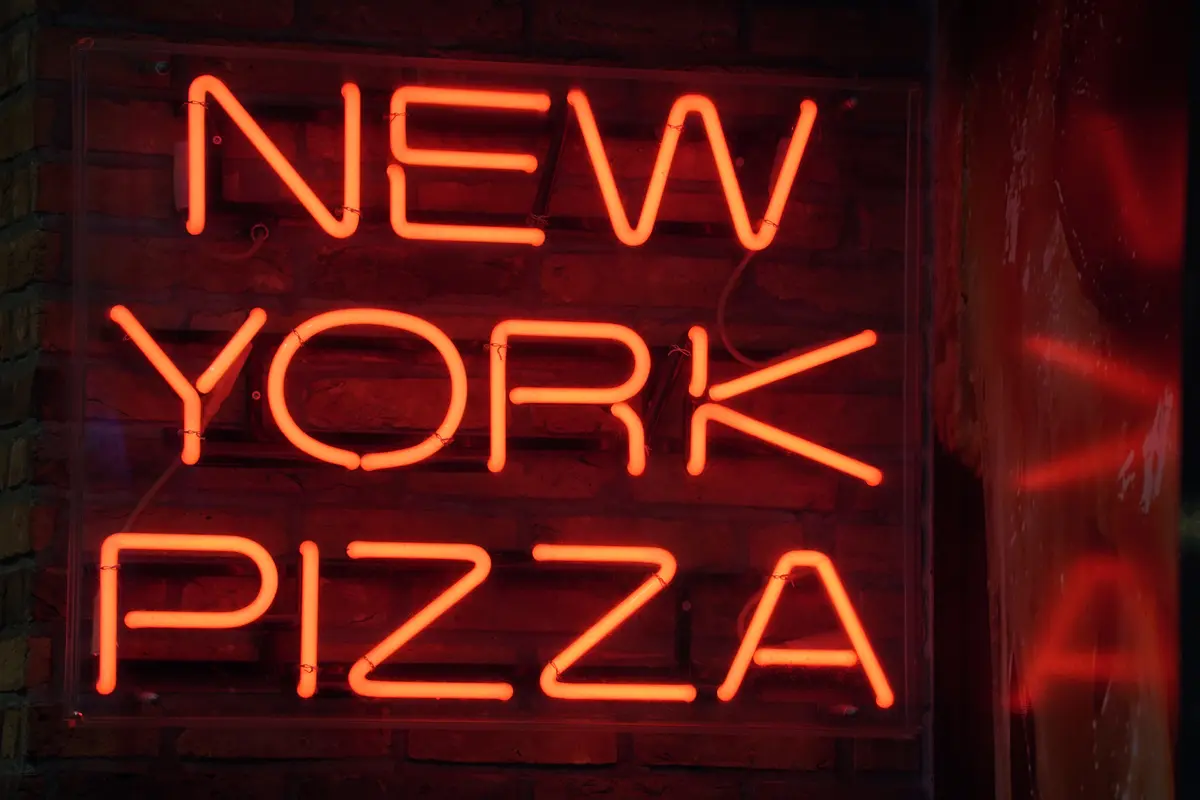 Neon New York Pizza sign outside WiseGuys Pizza
