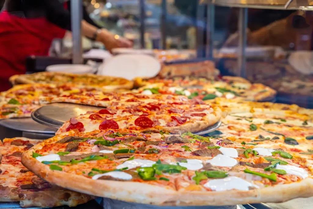 Variety of pizza selection with assorted toppings at WiseGuys Pizza