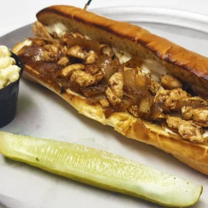 A mouthwatering chicken sandwich from Wise Guys Pizzeria, featuring tender chicken, melted cheese, and flavorful toppings