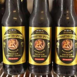 Three glass bottles of Manhattan Special Espresso Premium Coffee Soda, a carbonated coffee drink with retro-style label